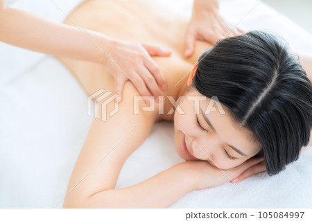 A young woman receiving an esthetics 105084997