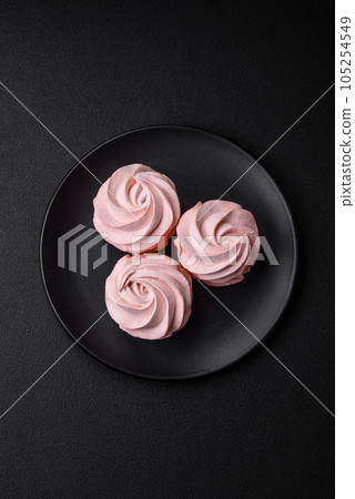 Delicious sweet colored marshmallow on a dark concrete background 105254549