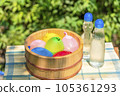 Water balloons in a wooden bucket and a cold bottle of ramune / Image of summer vacation, Showa retro, playing in the water in Japanese summer 105361293