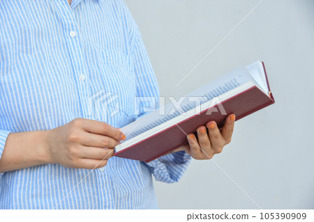 Young woman holding book in her hands , with space for text 105390909