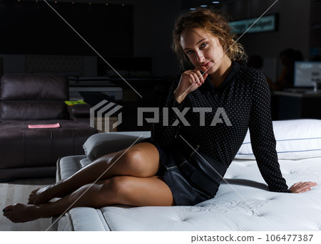 woman in black clothes posing on bed with new mattress 106477387