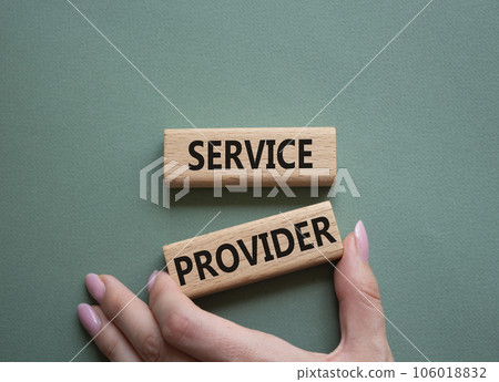 Service Provider symbol. Concept words Service Provider on wooden blocks. Businessman hand. Beautiful grey green background. Business and Service Provider concept. Copy space. 106018832