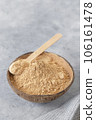 Bowl of healthy maca root powder on neutral grey background, vertical image 106161478