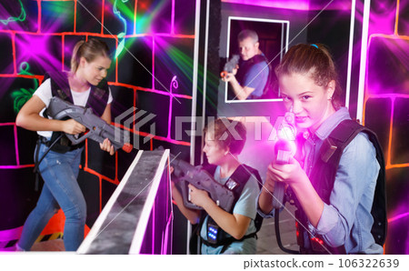 Teen girl with laser pistol on dark labyrinth 106322639