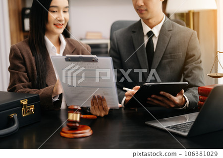 business people and lawyers discussing contract papers sitting at the table. Concepts of law, advice, legal services. in morning light. 106381029