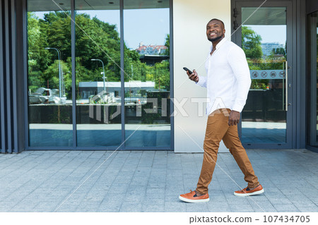 A young, successful African-American man with a smartphone in his hands 107434705