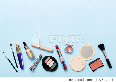 Professional makeup tools. Top view. Flat lay. Beauty, decorative cosmetics. Makeup brushes set and color eyeshadow palette on table background. Minimalistic style 107399401