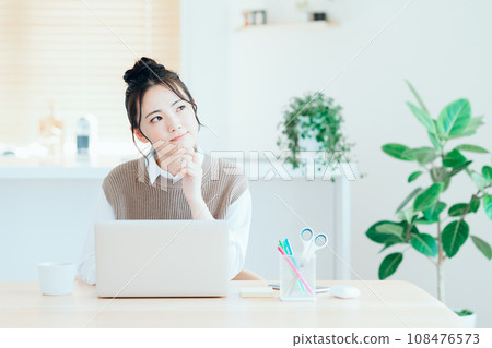 A young woman doing telework in the living room. 108476573