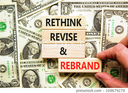 Rethink revise rebrand symbol. Concept word Rethink Revise and Rebrand on block. Dollar bills. Beautiful background from dollar bills. Business brand rethink revise rebrand concept. Copy space. 108679278