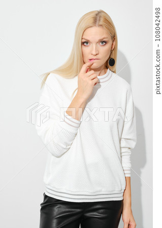 Distrustful or doubting woman biting her lip 108042498