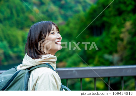 A woman enjoying hiking A woman refreshing herself in the mountains on holiday 109434813