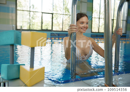 Young woman after training workout at swimming pool 109514356