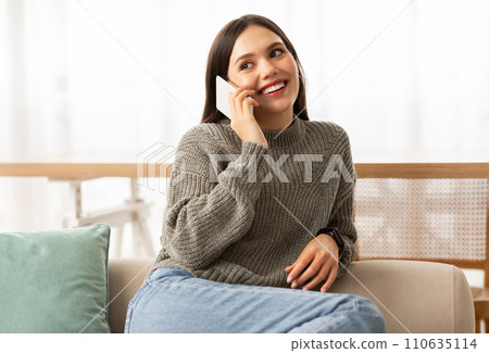 Happy young woman have phone conversation at home 110635114