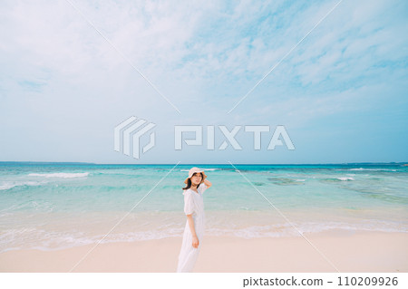 A woman relaxing on a beautiful tropical beach 110209926