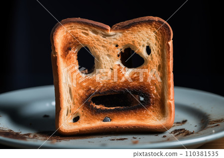 Burnt toast with an angry face expressing the emotion of sadness or sarcasm. 110381535