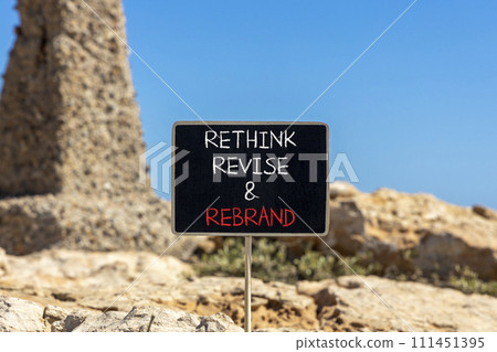 Rethink revise rebrand symbol. Concept word Rethink Revise and Rebrand on beautiful blackboard. Beautiful red stone background. Business brand motivational rethink revise rebrand concept. Copy space. 111451395