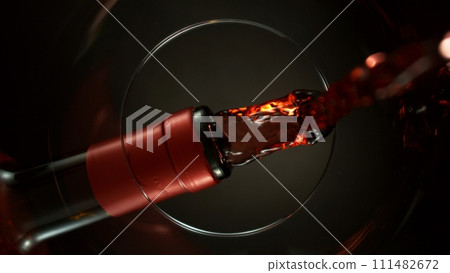 Pouring Red Wine into Glass, Macro Shot. 111482672