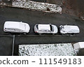 Three cars parked on street with snow on them. 111549183