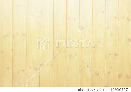 Background image of a vertical plank wall with light brown wood grain and knotty varnished paneling 111936757