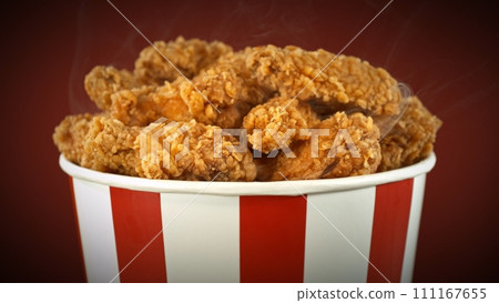 Fried Chicken Pieces in Paper Bucket, Isolated on Colored Background. Concept of Junk Food. 111167655