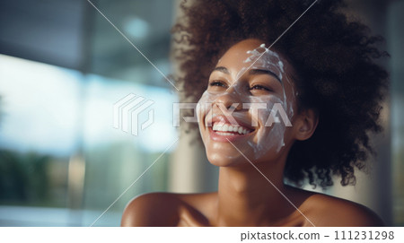 Woman enjoys skincare regimen, applying cream in bathroom mirror. 111231298