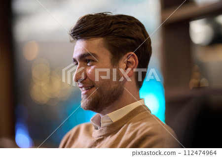 A close-up image captures a stylish man patiently waiting for his iftar meal during Ramadan, exuding an air of contemporary elegance and urban sophistication. 112474964