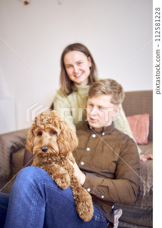 cockapoo in the hands of parents 112581228