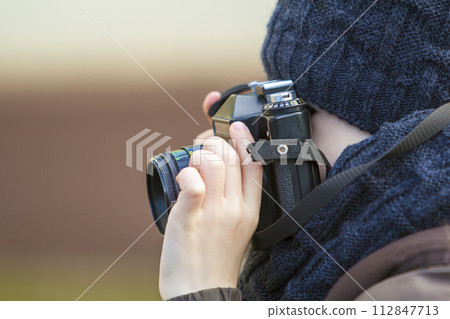 Portrait of little boy with vintage photo camera 112847713