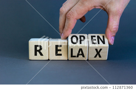 Relax and reopen symbol. Businessman turns cubes and changes the word 'relax' to 'reopen'. Beautiful grey table, grey background. Business, relax and reopen concept. Copy space. 112871360