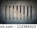 Match sticks burnt at different stages arranged in shape of a decreasing graph or chart. Business decrease conceptual background 112966424