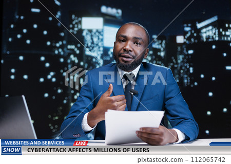 News anchor warns people about cyberattacks, discussing about hacked websites and stolen information. Online criminal activity affecting millions of users, reporter presenting daily events. 112065742