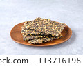 Seed crackers on wooden plate background 113716198