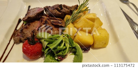 Gourmet grilled steak with roasted potatoes and fresh salad 113175472