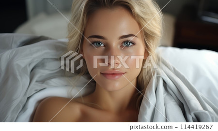 Woman in White Robe Sitting on Bed 114419267