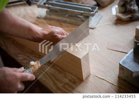 Carpenter working with a saw 114233455