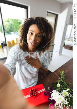 Biracial woman smiling at home, with copy space 115432158