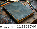 Book sitting on top of wooden table next to pair of glasses. 115896746