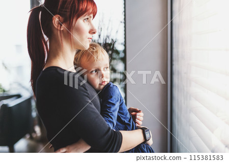 Mother holding toddler, carrying him around house. Unconditional paternal love, mother's Day concept. 115381583