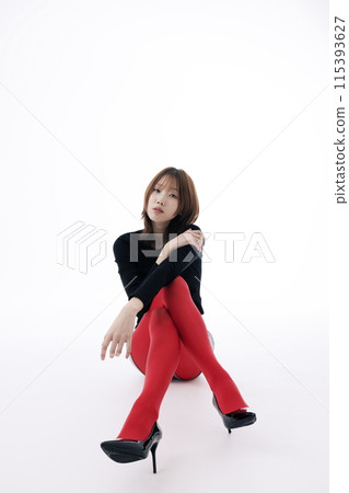 Korean Woman Sitting and Posing on the Floor in Red Leggings 115393627