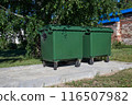 Two green trash cans on the street on a summer afternoon 116507982