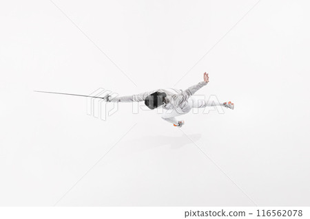 Fencer in white uniform and mask, captured from above in dramatic jump with their rapier against white studio background. 116562078