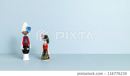 Banner Bulgarian Wooden Traditional Doll Souvenir in a Typical Bulgarian Folk Costume. It Contains Inside an Ampoule of the Famous Bulgarian Rose Oil Essence. Balkan Folk. Copy Space 116776230