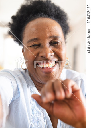 Portrait of happy senior african american woman having video call at home 116812481