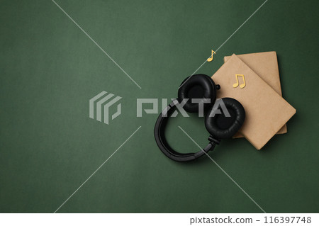 Books with modern headphones, audio book concept, on green background. 116397748