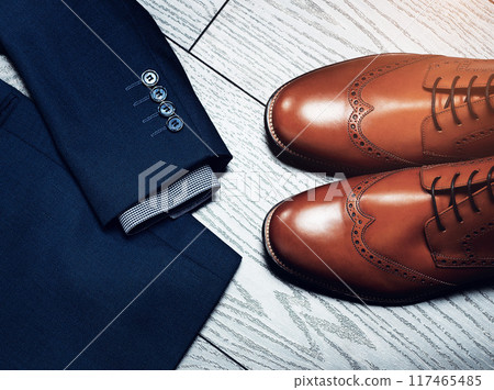 Fashion, flat lay and outfit for business on wooden surface from above for start of professional career. Shoes, style and suit with corporate clothes in studio for employment, job or occupation 117465485