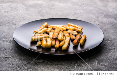 French potatoes on dark plate 117657268