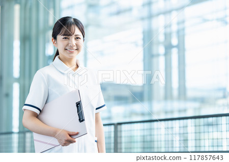 A female healthcare worker walks down the aisle. 117857643