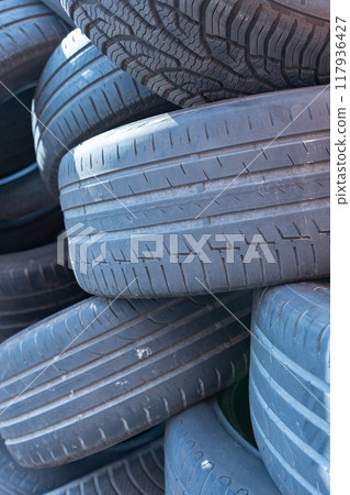 A dumpsite of old car tires. 117936427