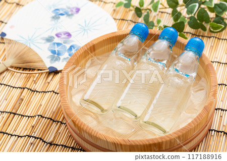 Ramune soda and festival fans cooled in a bucket of water and ice 117188916