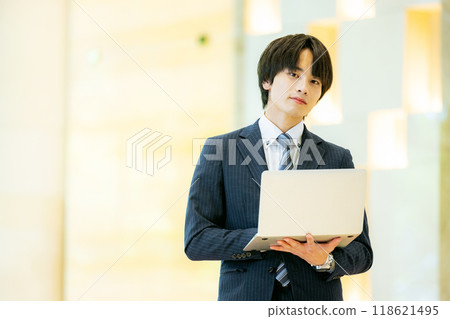 Businessman with a laptop, photo courtesy of Denpa Gakuen, Tokyo Electronics College 118621495